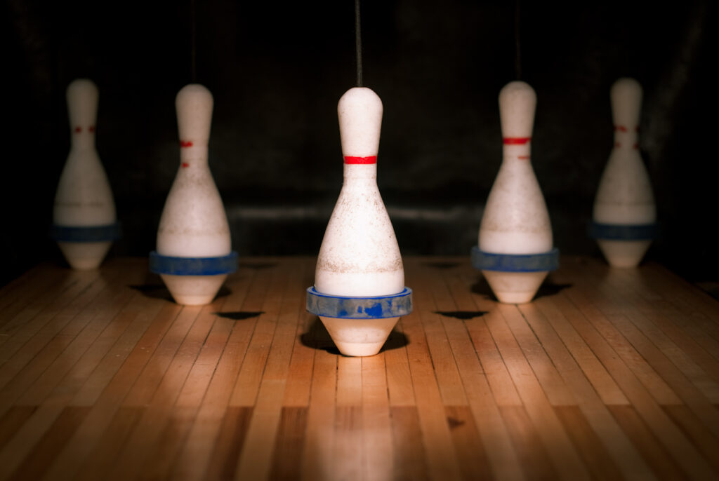 This image is of a 5 pin bowling game set up. There is a head pin and two pins on each side.