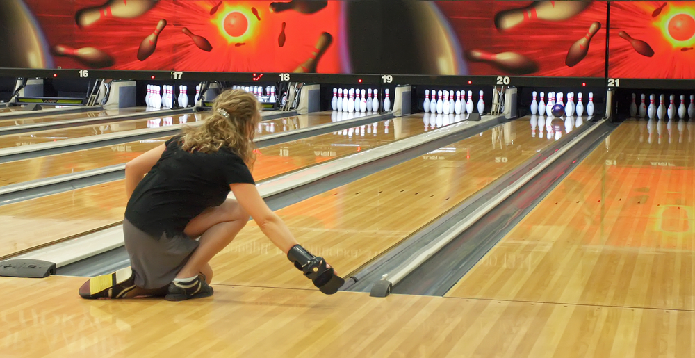 A young white woman that's using old bowling balls on an original pattern at vestavia bowling lanes in birmingham.