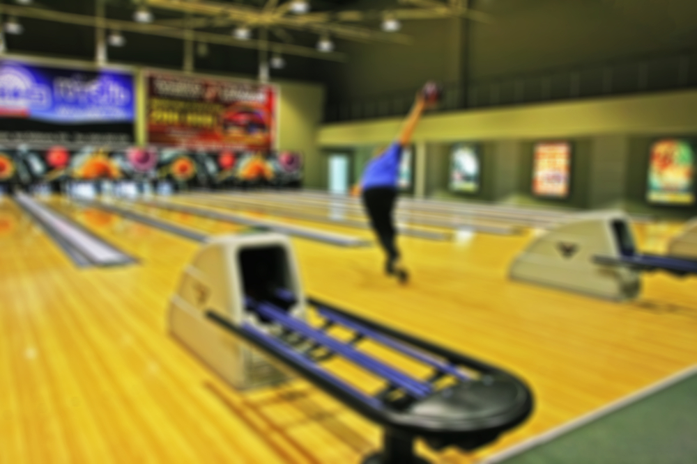 A male bowler with the best hook we've ever seen using finger inserts after resurfacing his ball with sanding pads.