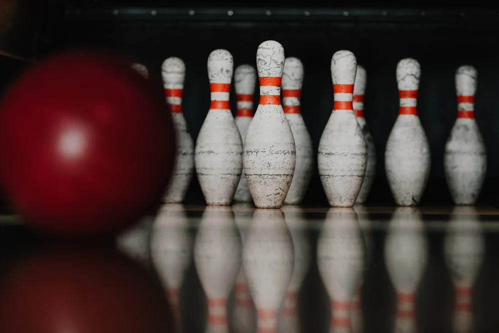 The image is of a bowling ball targeting set bowling pins. In relation to the type of game bowling is, the image is to connect the game of targeting to bowling.