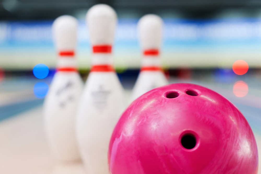 A close-up angle of a bowling lane after a lady had her plastic bowling ball drilled with a balance hole.