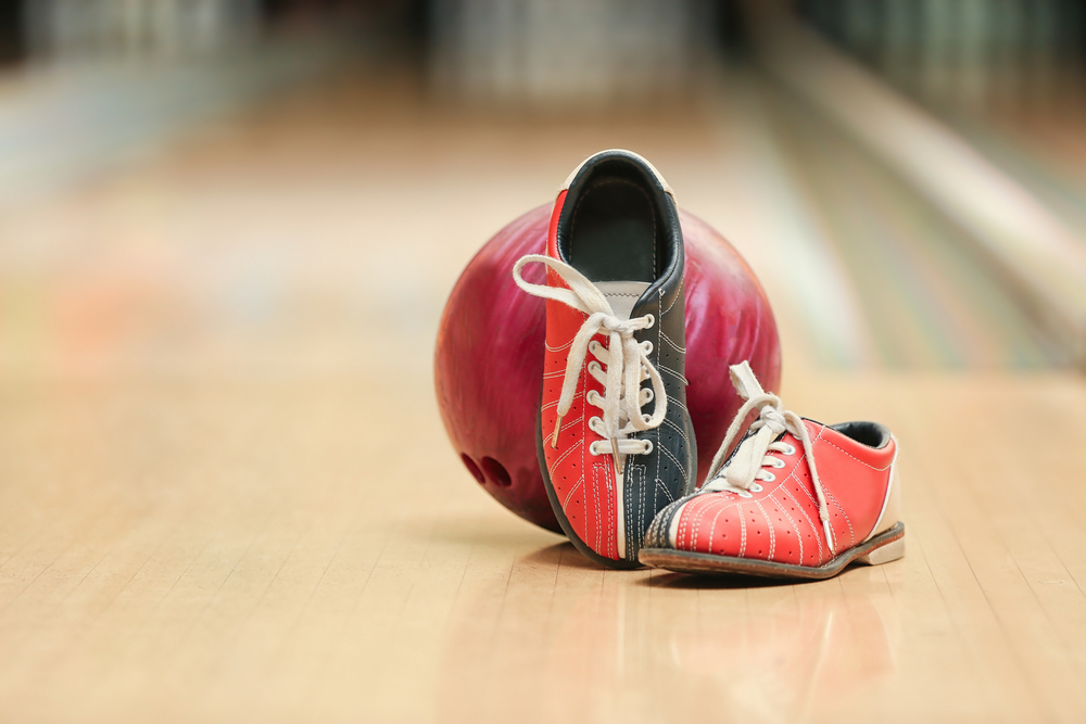 A pair of bowling shoes made from a leather-like microfiber material without a sliding sole or interchangeable soles.