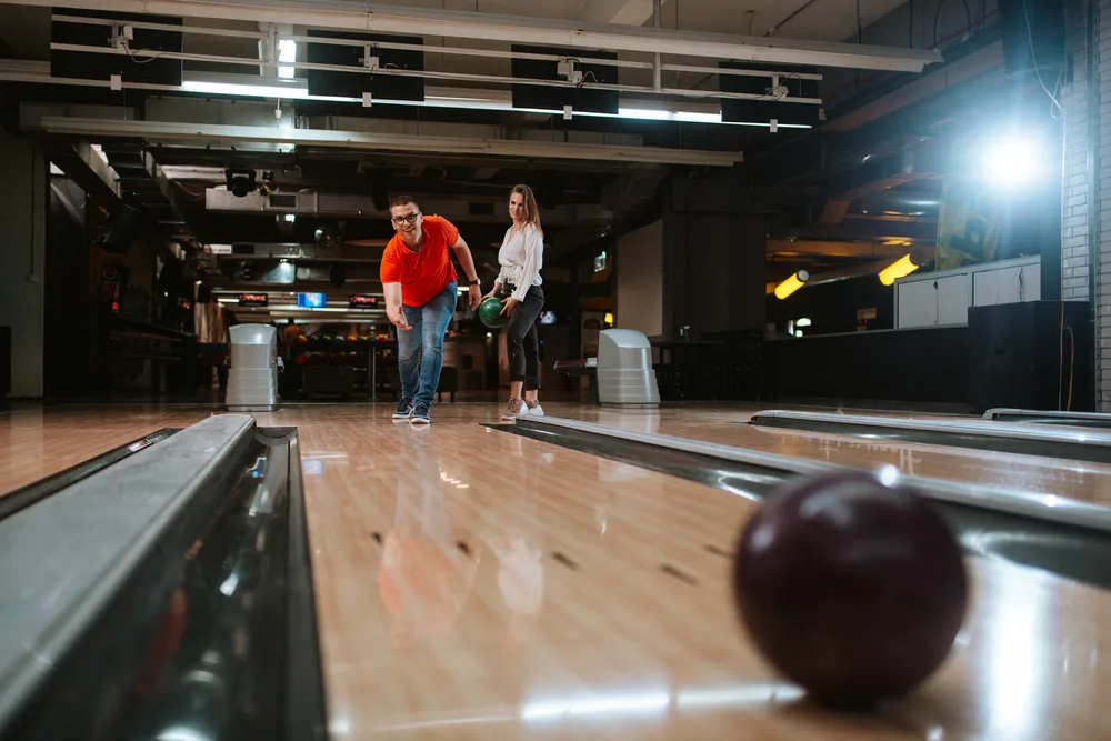 Two casual bowlers use one of the best urethane bowling balls with a weight block for beginner bowlers.
