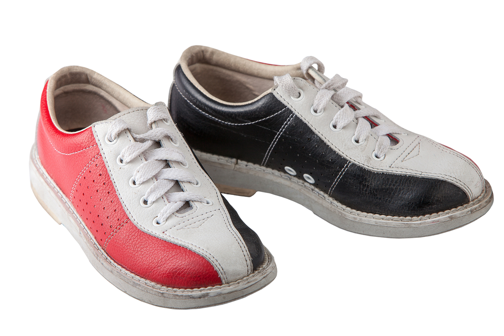 Tri-colored red, white, and blue bowling shoes that were recently cleaned with a steel wire brush to remove dirt.