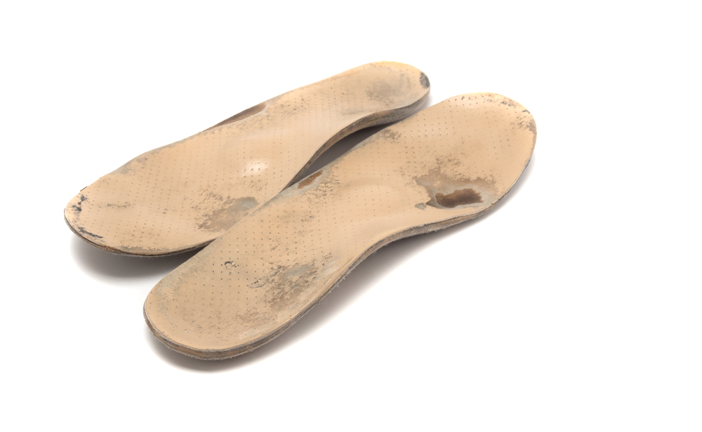 Shoe insoles that are visibly worn and should be removed from the shoe, and with water and dish soap, wiped with micro fiber towel to remove any possible green mold.