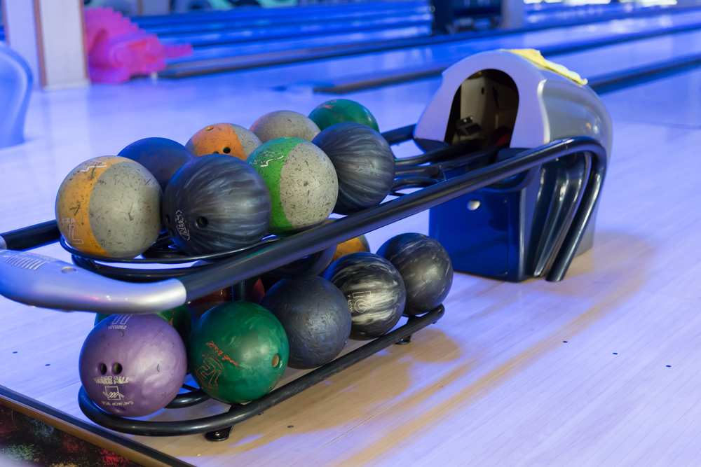 A bowling ball return machine shows several house ball or straight ball options at a local alley in tennessee.