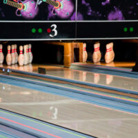 A bowling center with regulation bowling lane dimensions with a tongue and groove design for a smoother surface and house pattern.