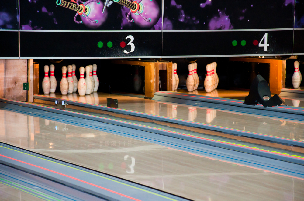 A bowling center with regulation bowling lane dimensions with a tongue and groove design for a smoother surface and house pattern.