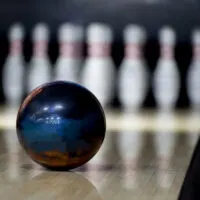 A 16-pound bowling ball, the best professional ball weight for ball speed and power, speeding down the lane.