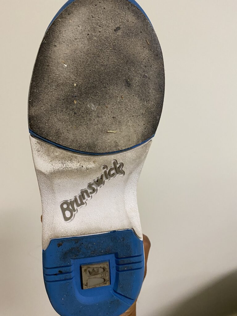 The bottom of the shoes shows dirty slide strips to be cleaned with a wire bristled brush, with just enough pressure not to damage the slide pad. Wearing shoe covers help to minimize the dirt on the slide soles.