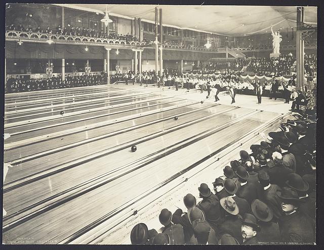 Black and white image of multiple bowling lanes built around the 1900s. Due to the timeframe, real wood was probably used to create the lanes, and the were higher maintenance costs.