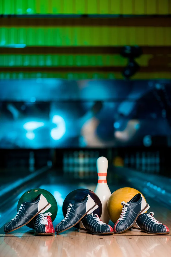 A part of their bowling equipment collection are three pairs of tri-colored bowling shoes. The goal is to keep their bowling shoes clean and well maintained.