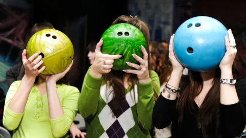 Three bowling balls showing the conventional drill 3 finger holes for bowling