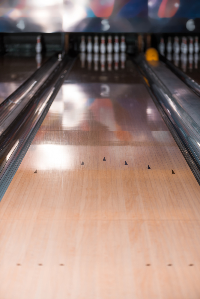A standard bowling lane used by all bowling leagues with arrow markings and dot placements.