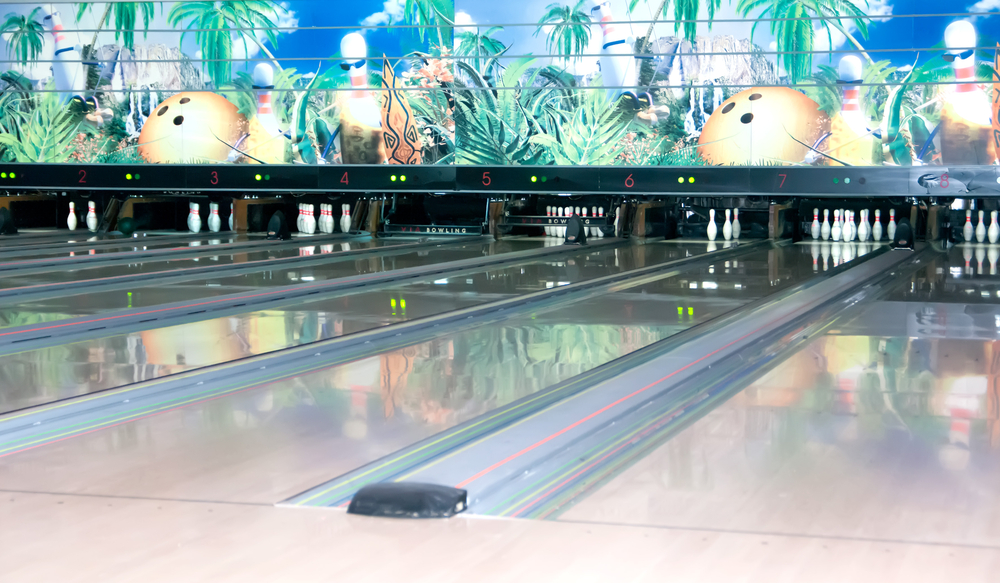 Three lanes show spares that resulted after the bowler rolled their second ball and left the pins remain standing.