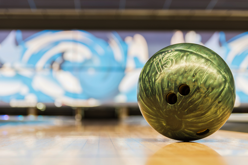 An actual bowling ball sitting on a bowling lane after bowling ball points were calculated.