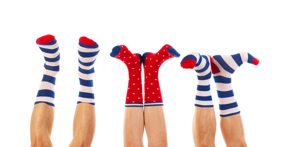 Super cute striped and dotted socks isolated over white background.