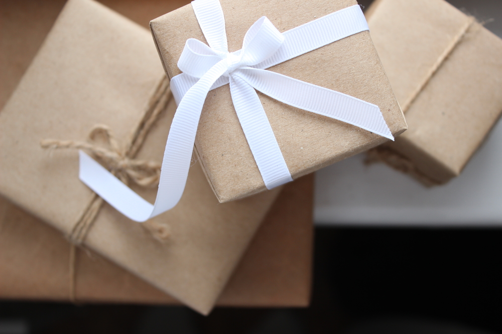 Brown gift boxes tied with white ribbon and  string for the bowling enthusiasts.