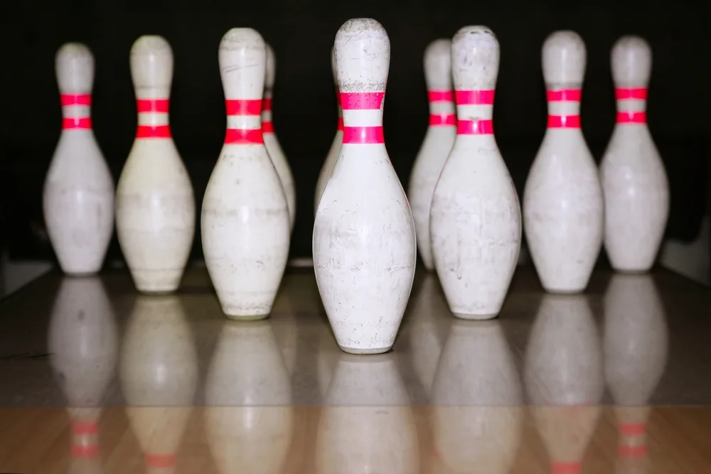 Bowling pins on a wooden floor. Bowling pins and other gear are great gift ideas.