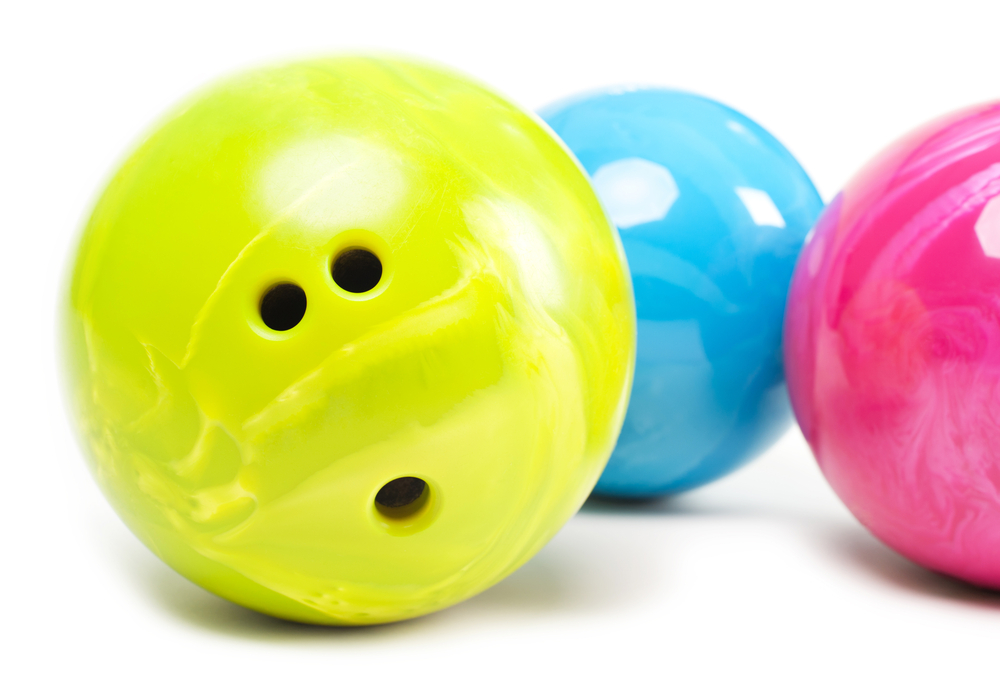 Three bowling balls neon yellow, neon blue and neon pink have standard ball performance.