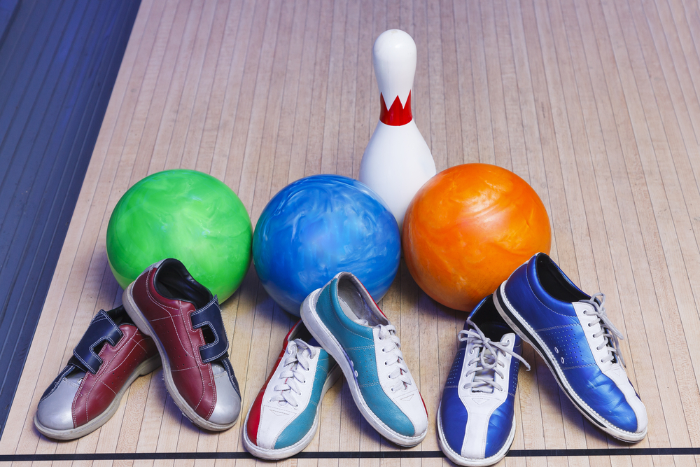 Three bowling balls, green, blue and oranged and three pairs of bowling shoes, were cleaned as a result of a sticking bowling shoe. Sticking bowling shoe requires a deep cleaning of the shoes' sole.