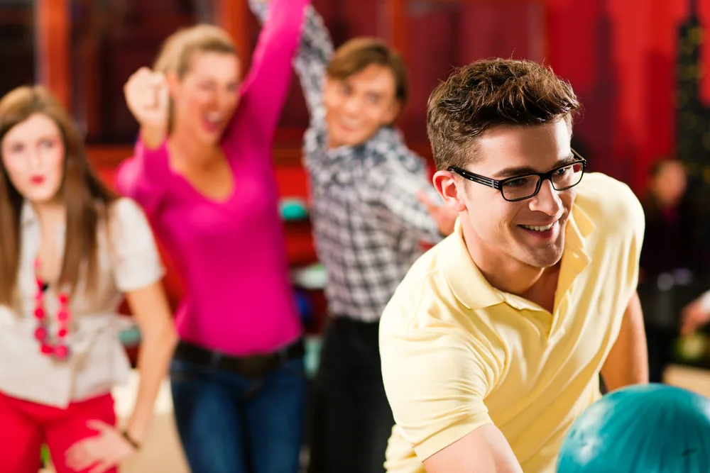 The guy in the yellow shirt and black glasses is looking for bowling coaches with a lesson package that offers video analysis and lane coaching.