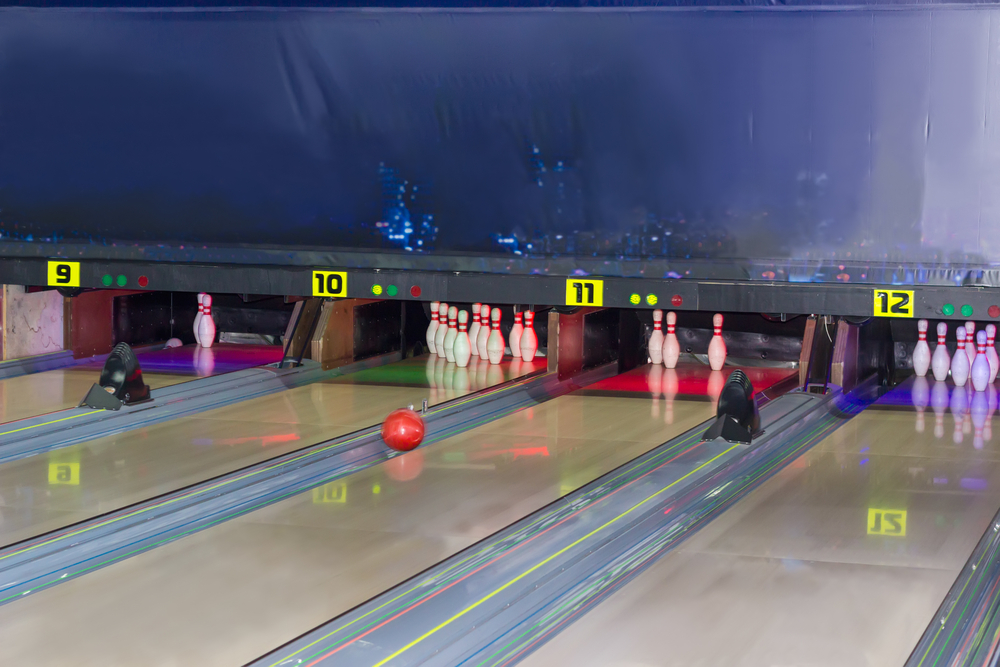 Shot that includes four bowling lanes in one picture, on lane 11, if the bowling is aimed at only one pin, they can clear the other pin as well.