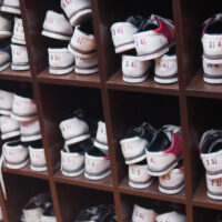 Display of various sized rented shoes at the local bowling alley