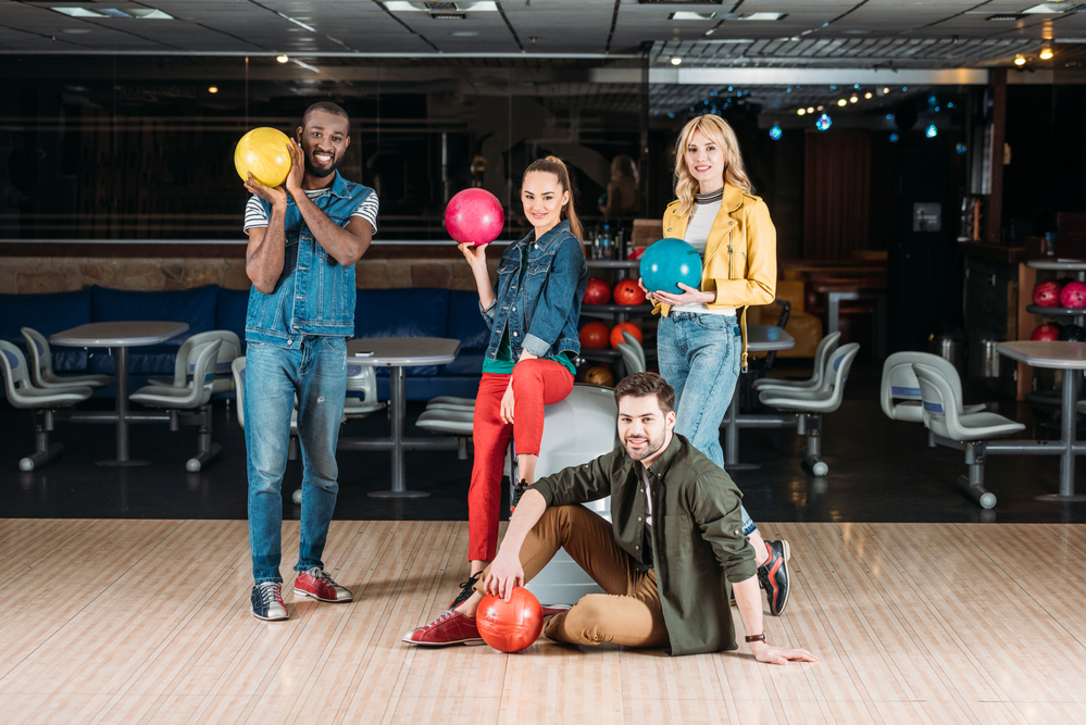 Teams bowl in a scheduled match for fund prizes, while cheering each other on.