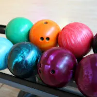 Drilled, multi-colored bowling ball return. Note a new bowling ball ships undrilled.