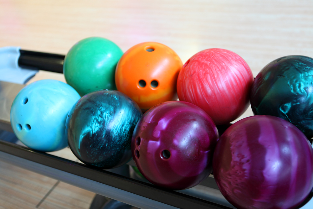 Drilled, multi-colored bowling ball return. Note a new bowling ball ships undrilled.