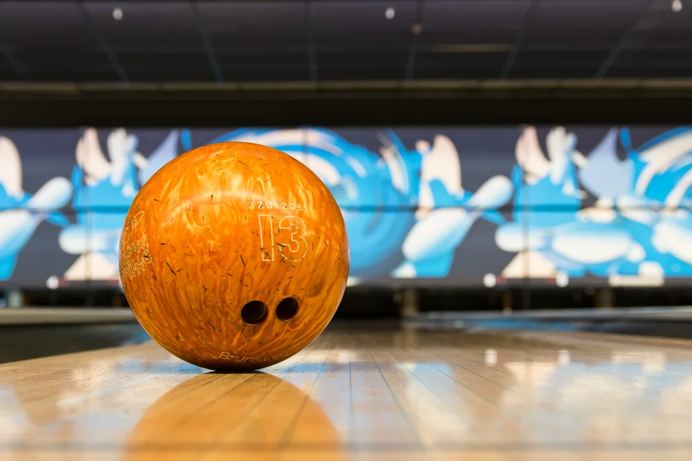 A good place to start cleaning this orange bowling ball is with homemade bowling ball cleaning products.
