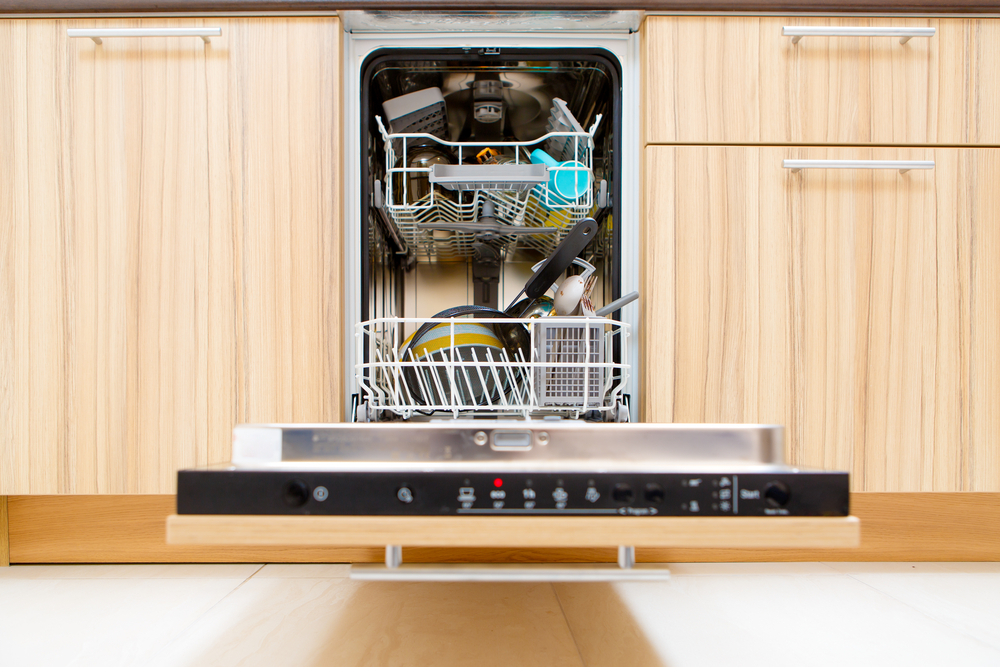 After soaking inside, an open dishwasher with a bowling ball goes through the heated dry cycle.