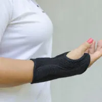 A lady that loves to bowl decides to wear wrist support to keep her wrist firm following carpal tunnel syndrome.