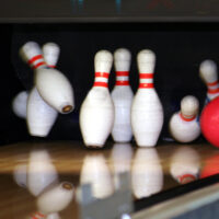 The red ball made two strikes, and all the pins were knocked down, leaving the next ball (or the last ball) useless.