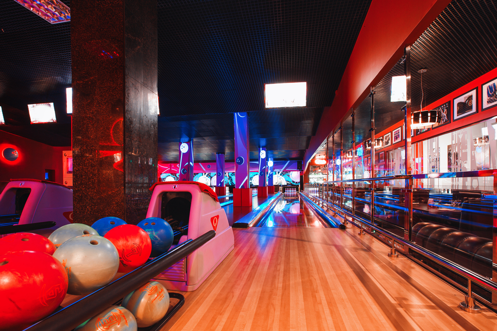 The bright and colorful lights create a fun and memorable bowling alley experience.