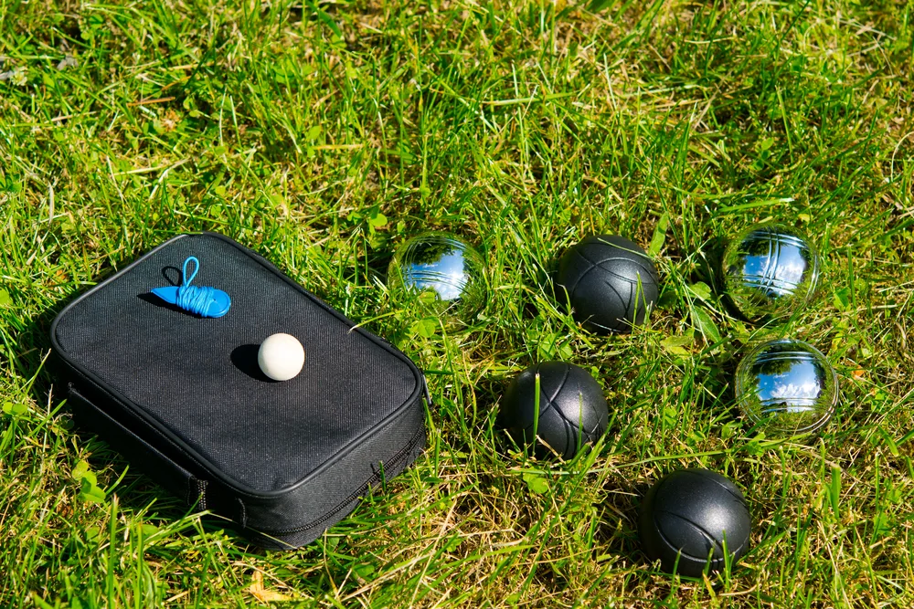Standard bocce ball sitting on a lawn is 107mm (4. 2″) and weighs 920 grams (2lbs).