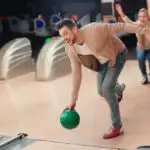 Male bowler with green ball using cardio as he makes several trips to the line