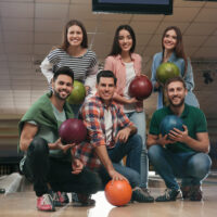 The guy in the green shirt is the third best bowler and can inspire the team or intimidate the opposing team when he bowl a good frame.