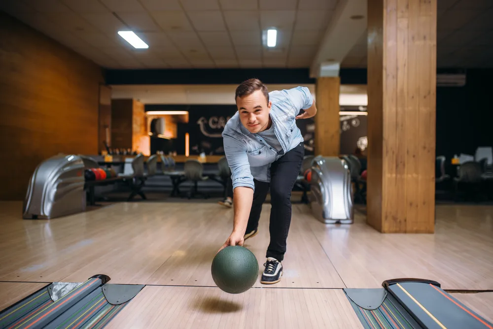 The reason the bowling ball is falling out the bowlers hand is because of a gravitational force exerted by the earth.