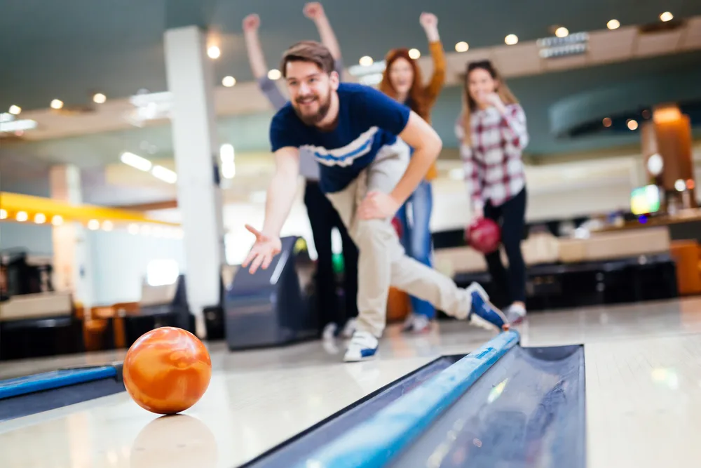 The male bowler has two urethane bowling balls.