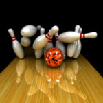 The orange and black swirl bowling ball hit the head pin and the remaining pins hit each other like dominos.