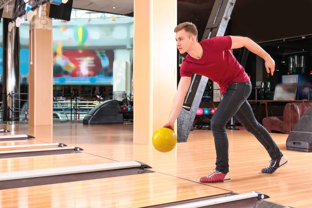 The bowler in the red shirt with the yellow ball, used their left foot as their slide foot.