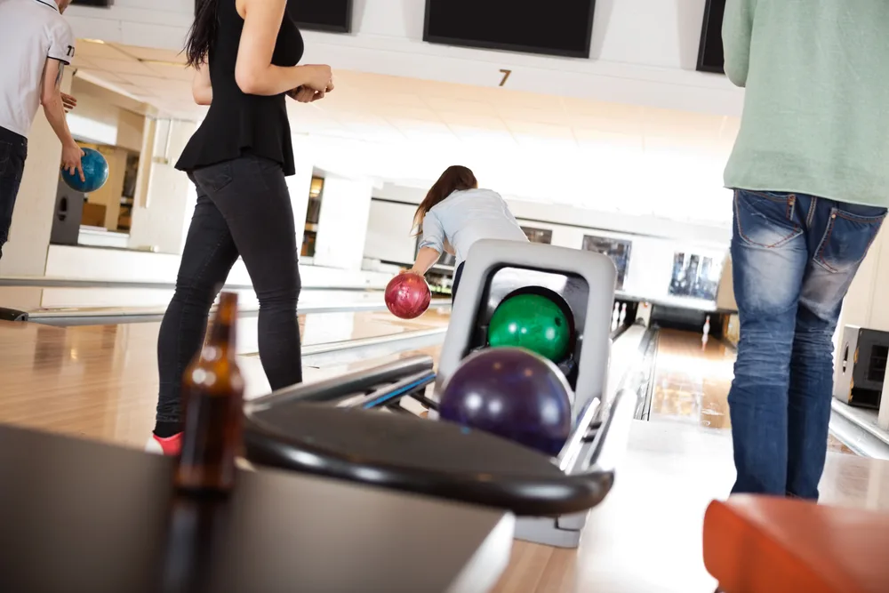 Bowlers practicing at the alley to correct their form to prevent serious injury.