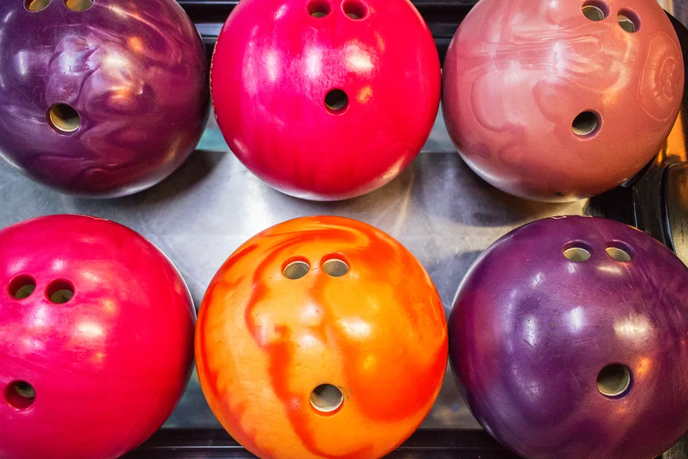 The types of bowling balls on the ball returned are performance bowling balls in a variety of colors.