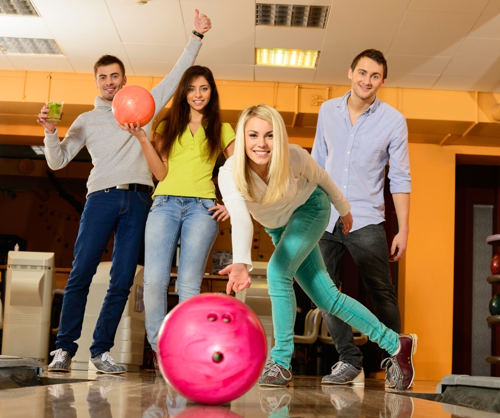 The lady bowler in the white shirt increased her ball speed by raising her hand higher.