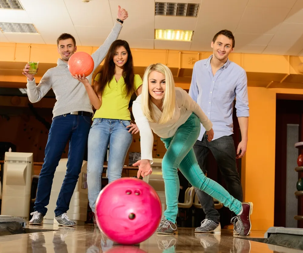 Bowling Balls With The Most Hook: Our Top 8 Aggressive Balls 1 The lady bowler in the white shirt increased her ball speed by raising her hand higher.