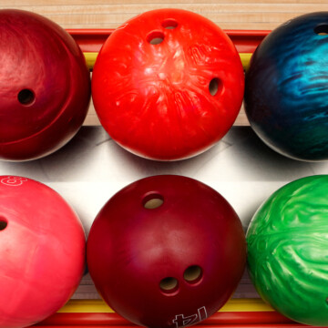 Bowling balls on ball return at bowling alley