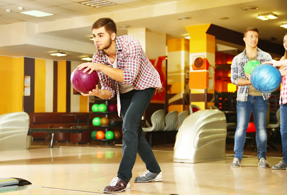 Friends playing in bowling club realized the alley does all the scoring for you