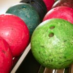 Bowling balls that have clearly been worn and chipped and damaged